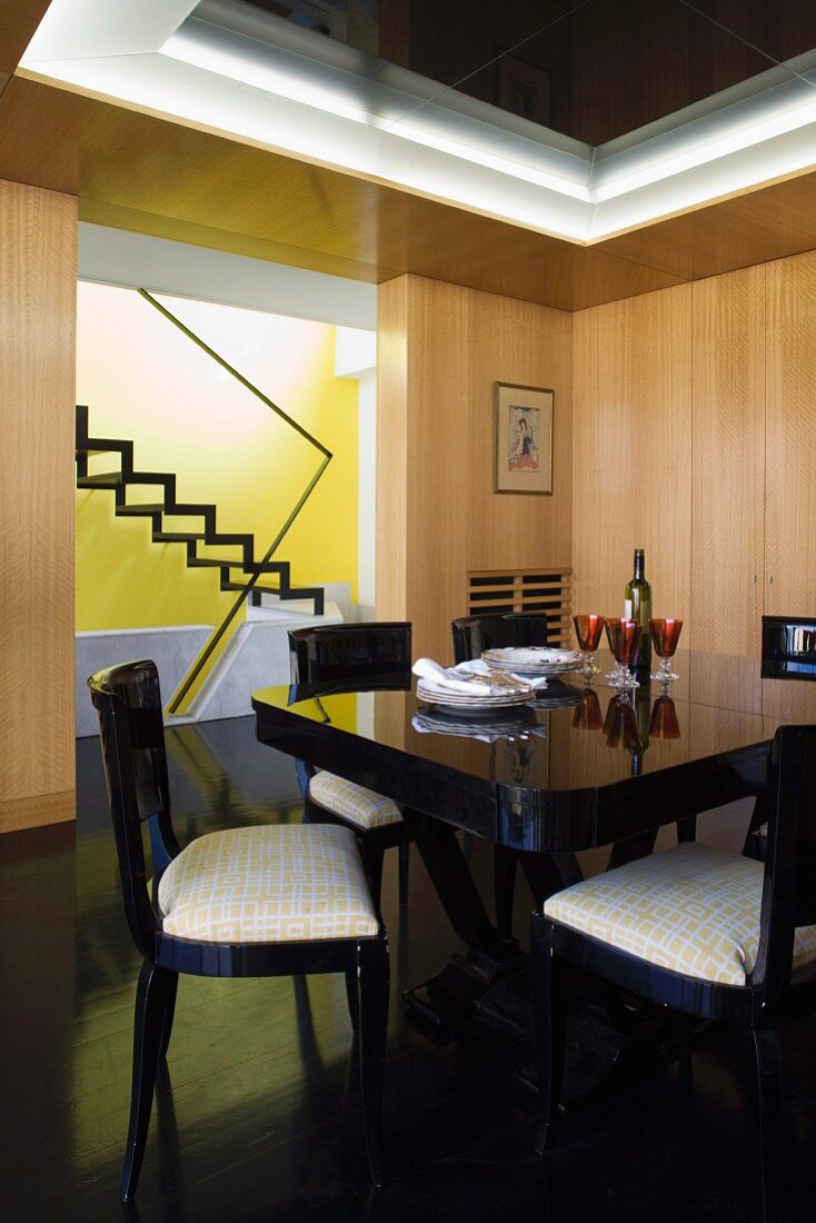 Black, Art-Deco dining set in wood-panelled dining room