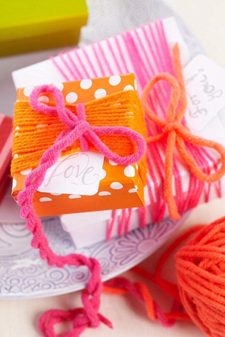 Simple gift box wrapped in colourful woollen yarn