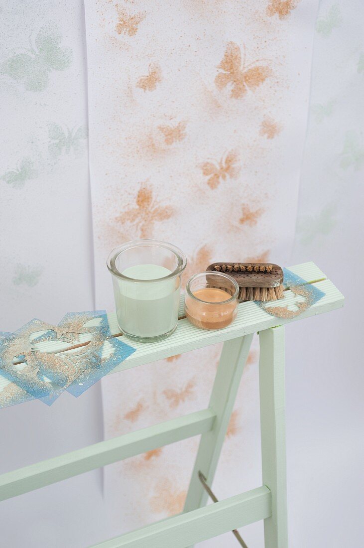 Wallpaper decorated with stencilled butterflies