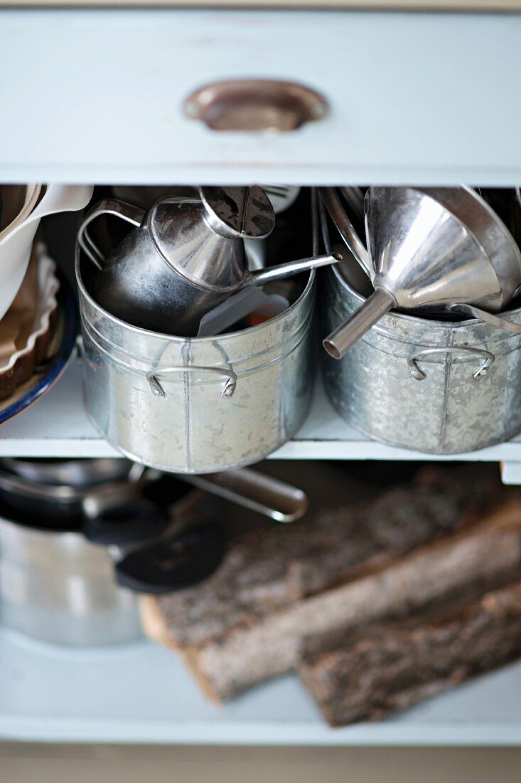 Zinc pots on open-fronted shelves