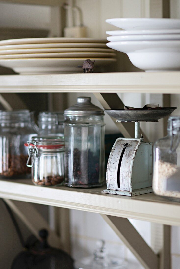 Storage jars and plates on open-fronted shelves