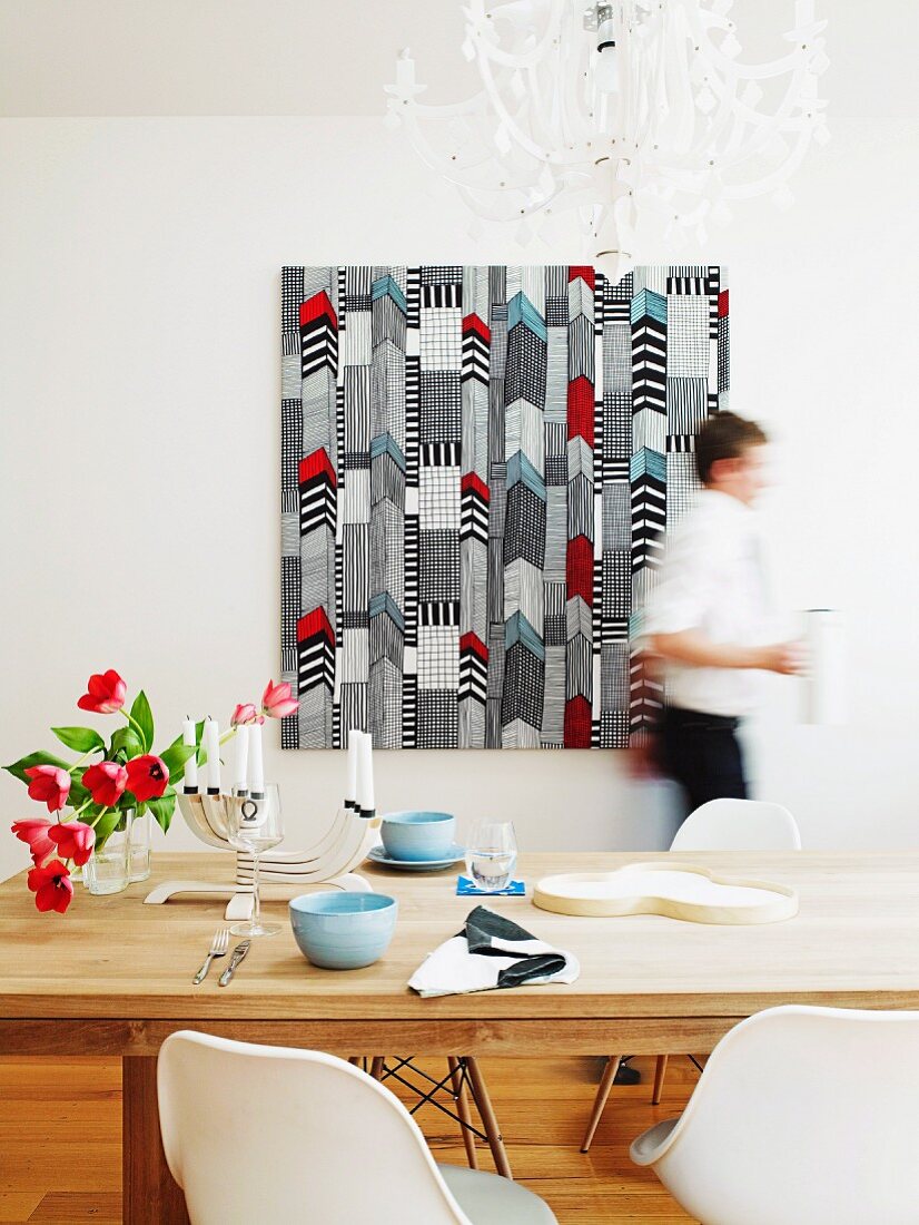 Marimekko fabric wall hanging behind set dining table