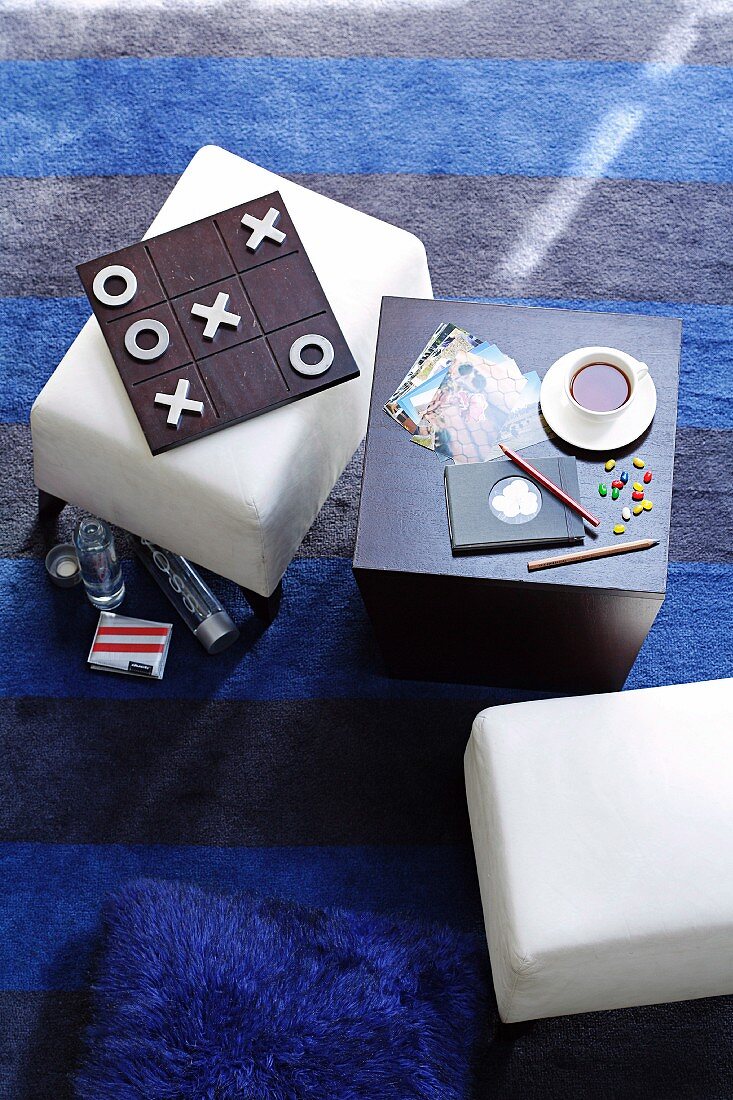 Cube table, board game and white stools