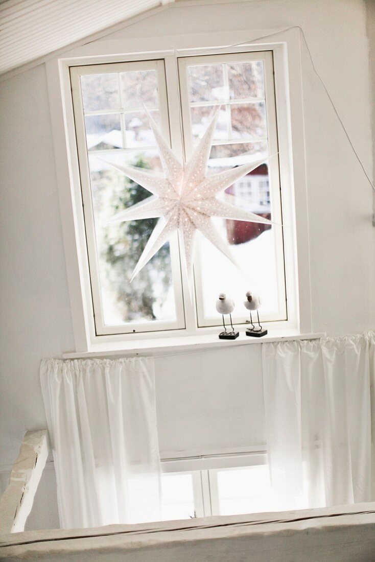 White paper star lamp decorating window
