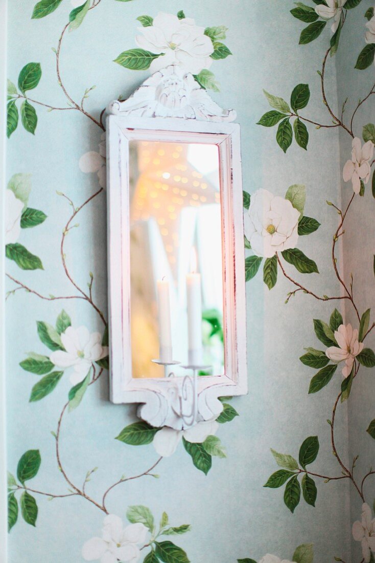 Candle in white, shabby-chic mirrored candle scone on romantic floral wallpaper