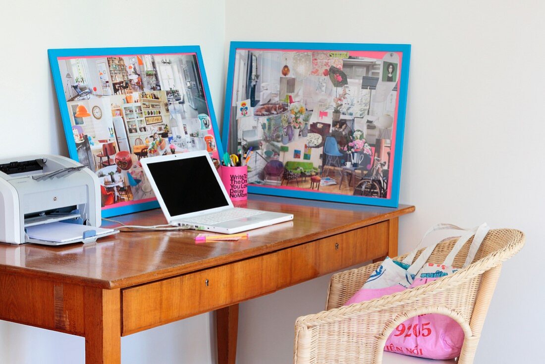 Laptop, printer and framed collages on delicate fifties-style bureau