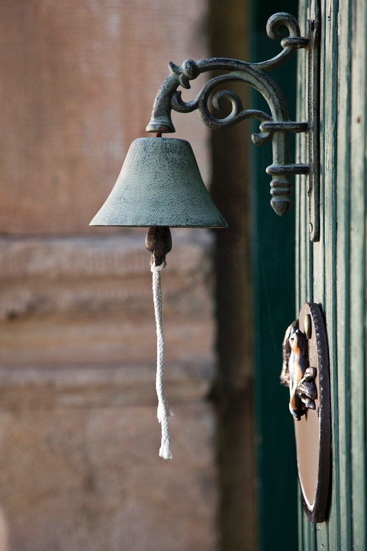 Metal bell on wall
