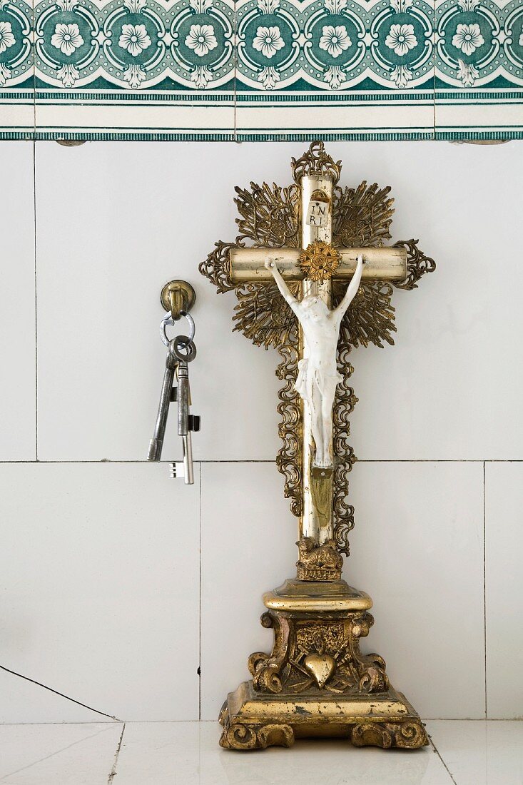 Crucifix and keys on a shelf
