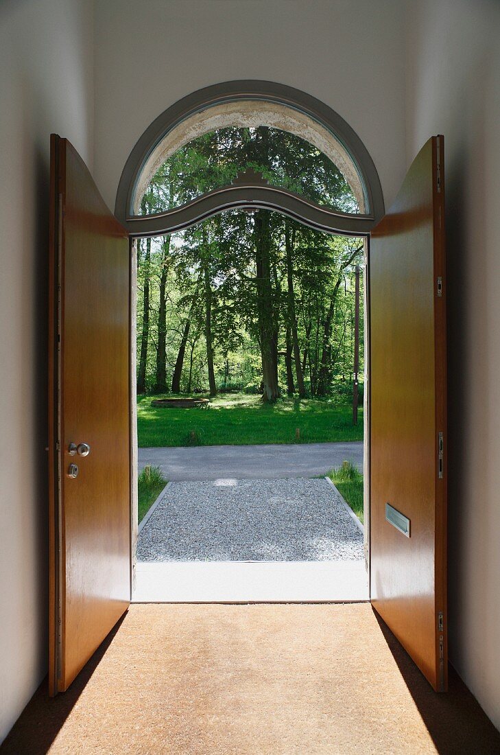 Open double front door with arched transom window