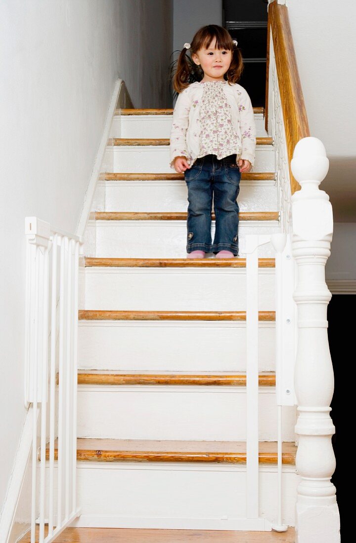 Young girl standing on a staircase