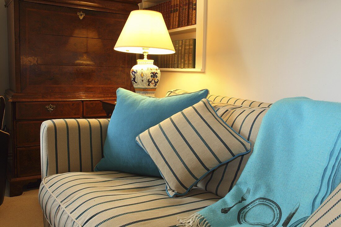 Decorative cushions on a sofa with a striped cover