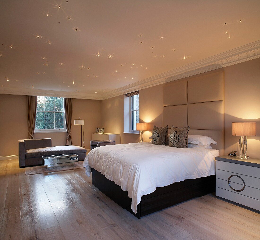 Starry sky in a spacious bedroom with double bed and upholstered head board