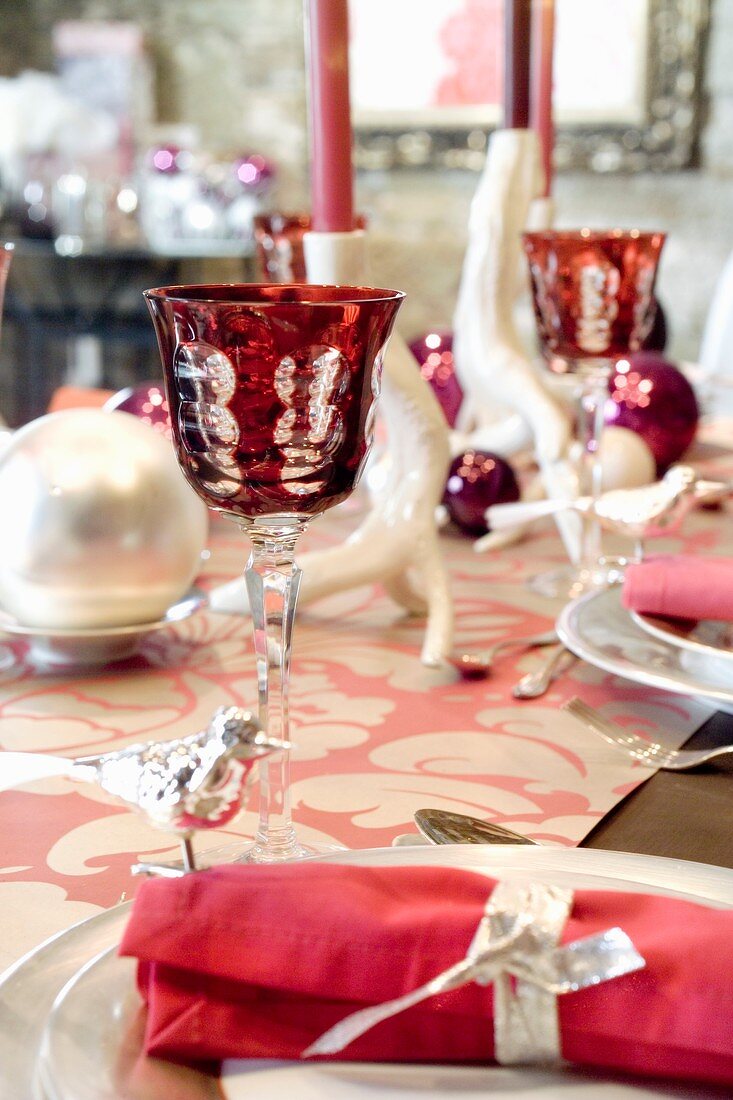 A table laid for Christmas dinner decorated in pink