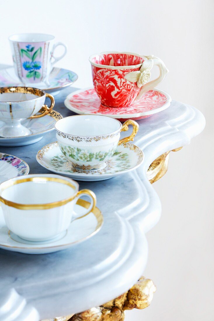 Assorted cups on a marble top table