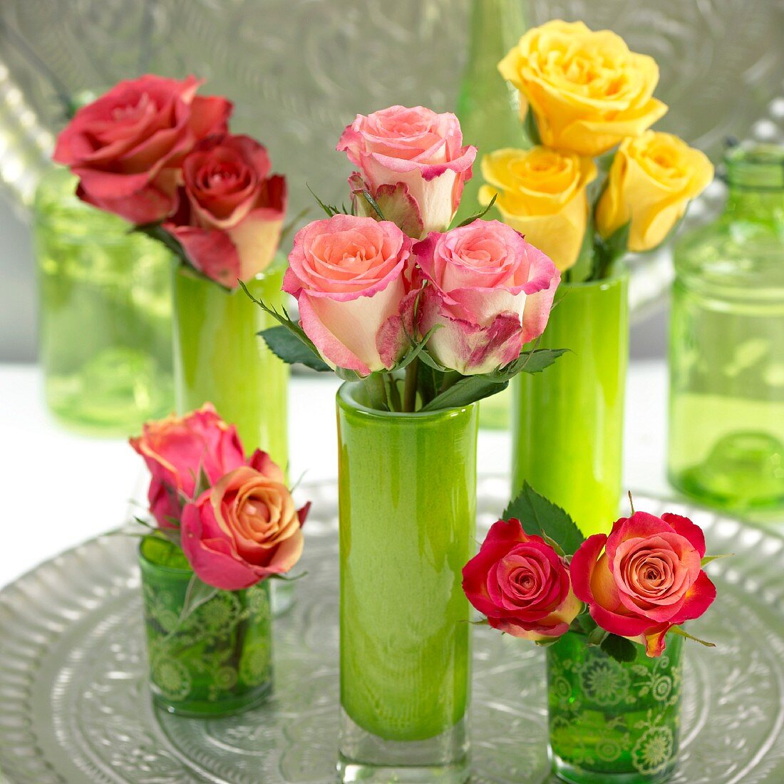 Assorted roses in vases as table decorations