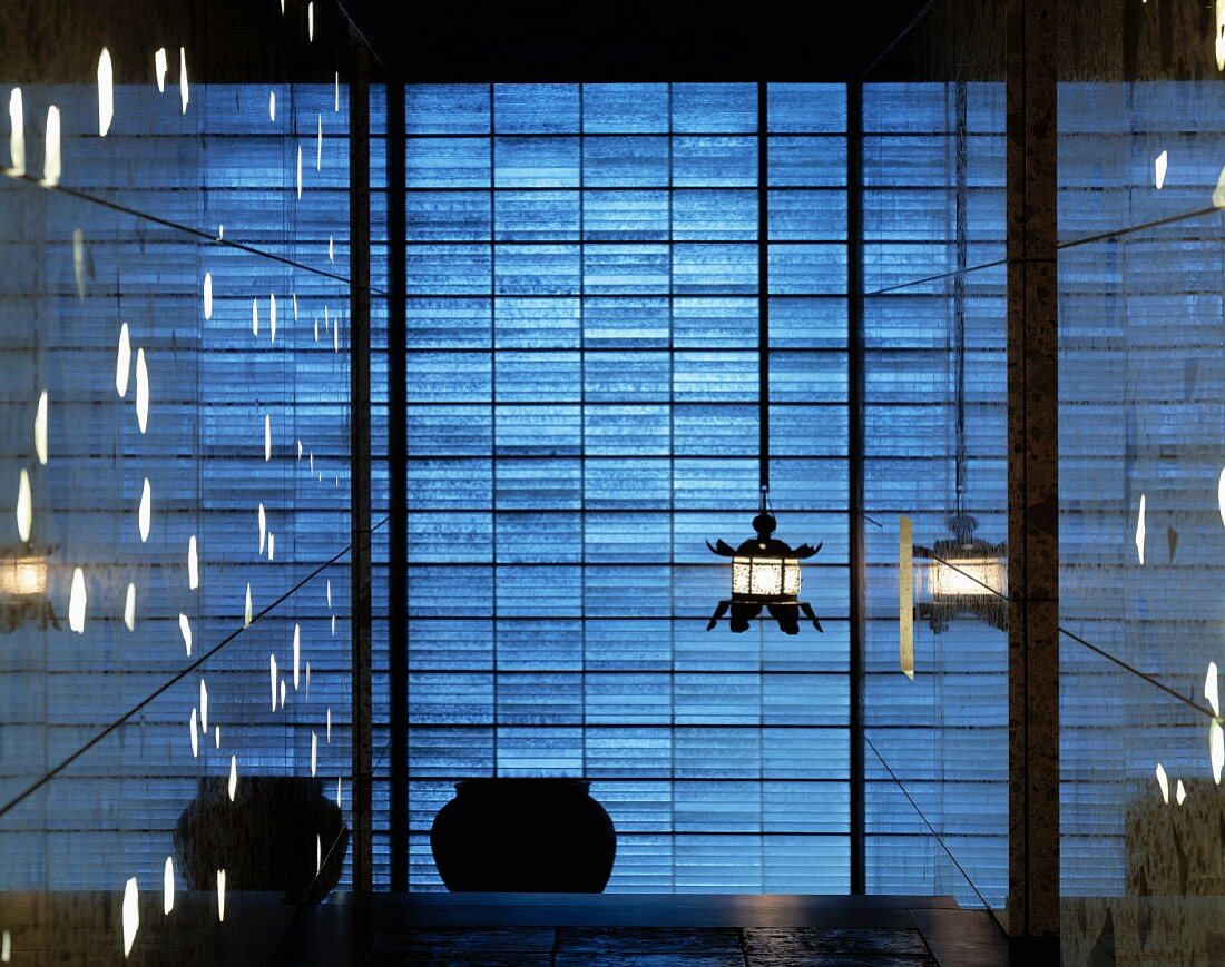 Lobby with hanging lamps in front of a blue, shimmering wall