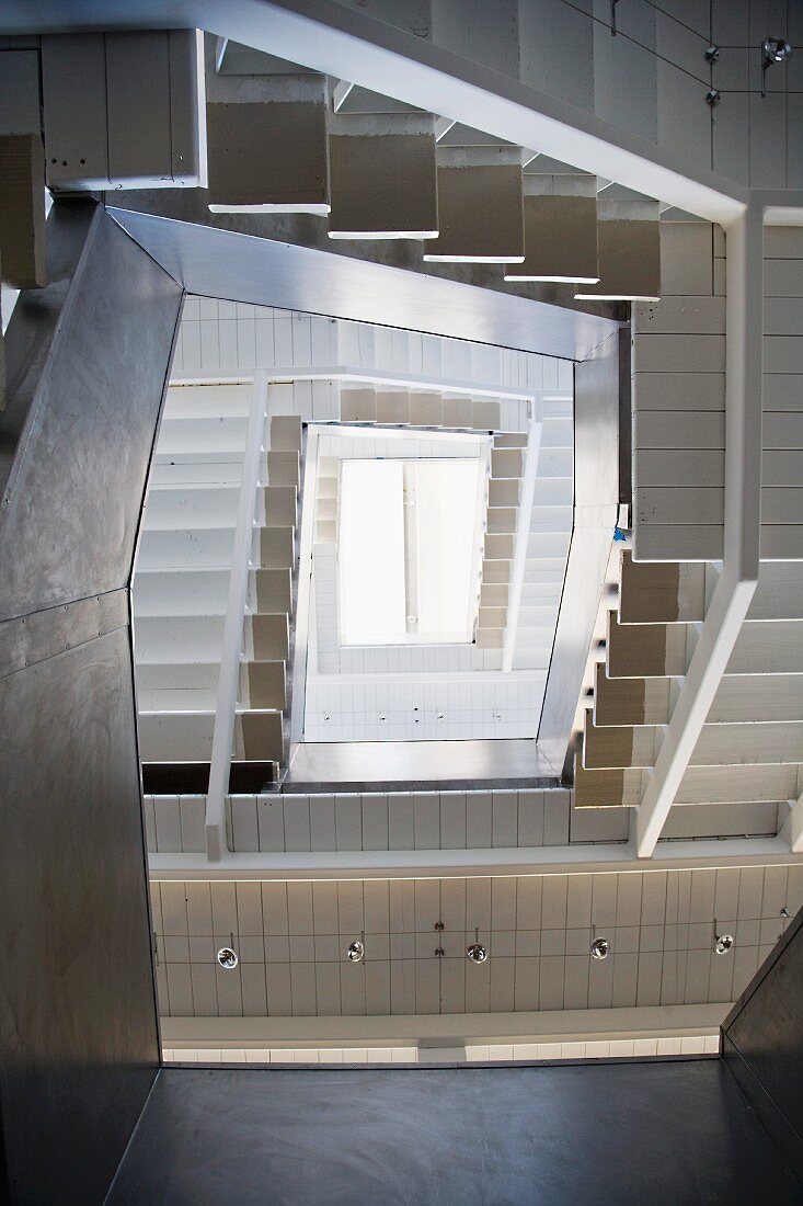 A view through a contemporary stairwell to a skylight