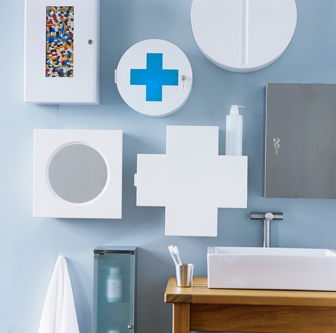 A collection of wall cupboards in various shapes on a light blue wall