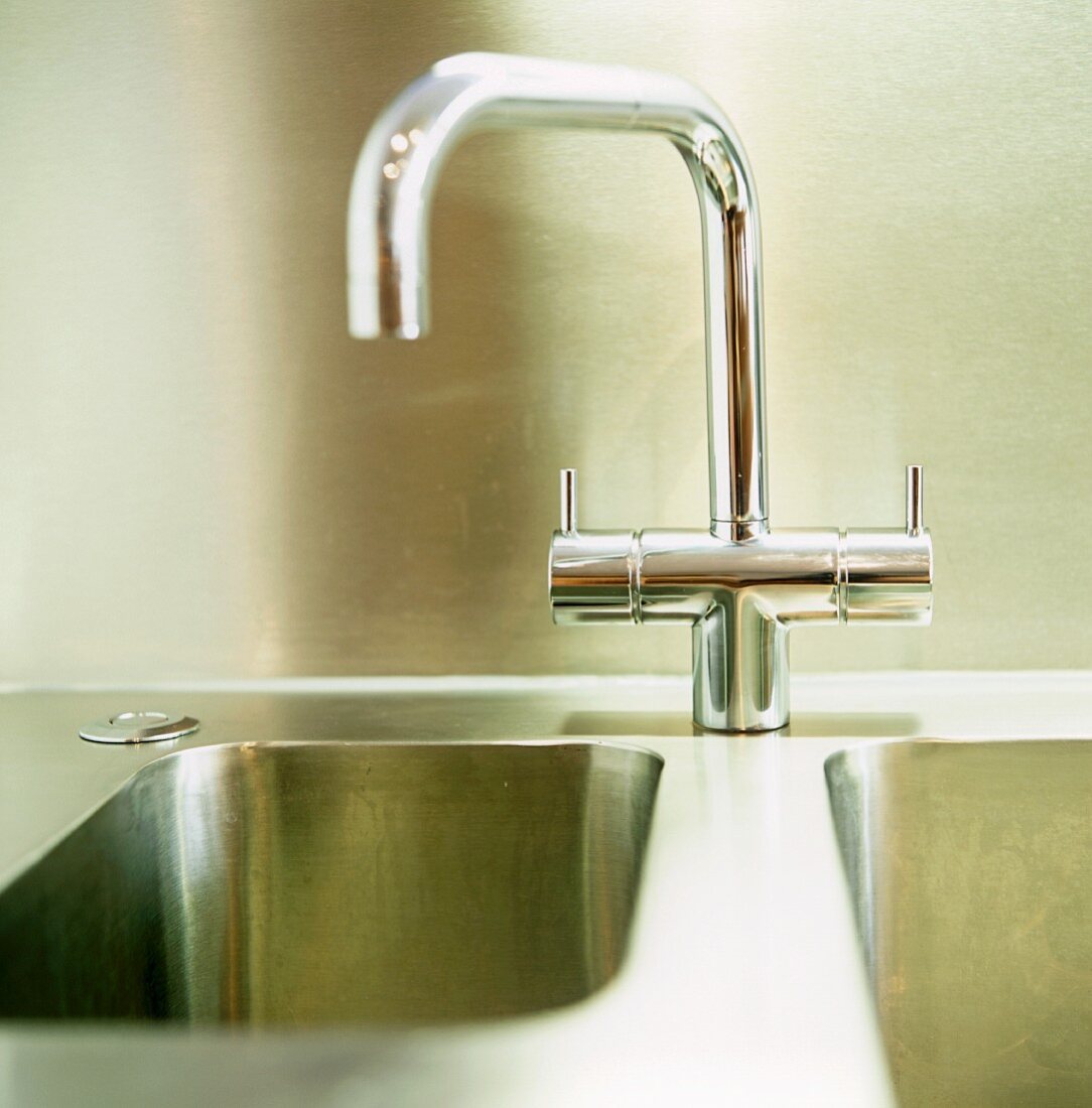 A chrome designer kitchen tap on a sink