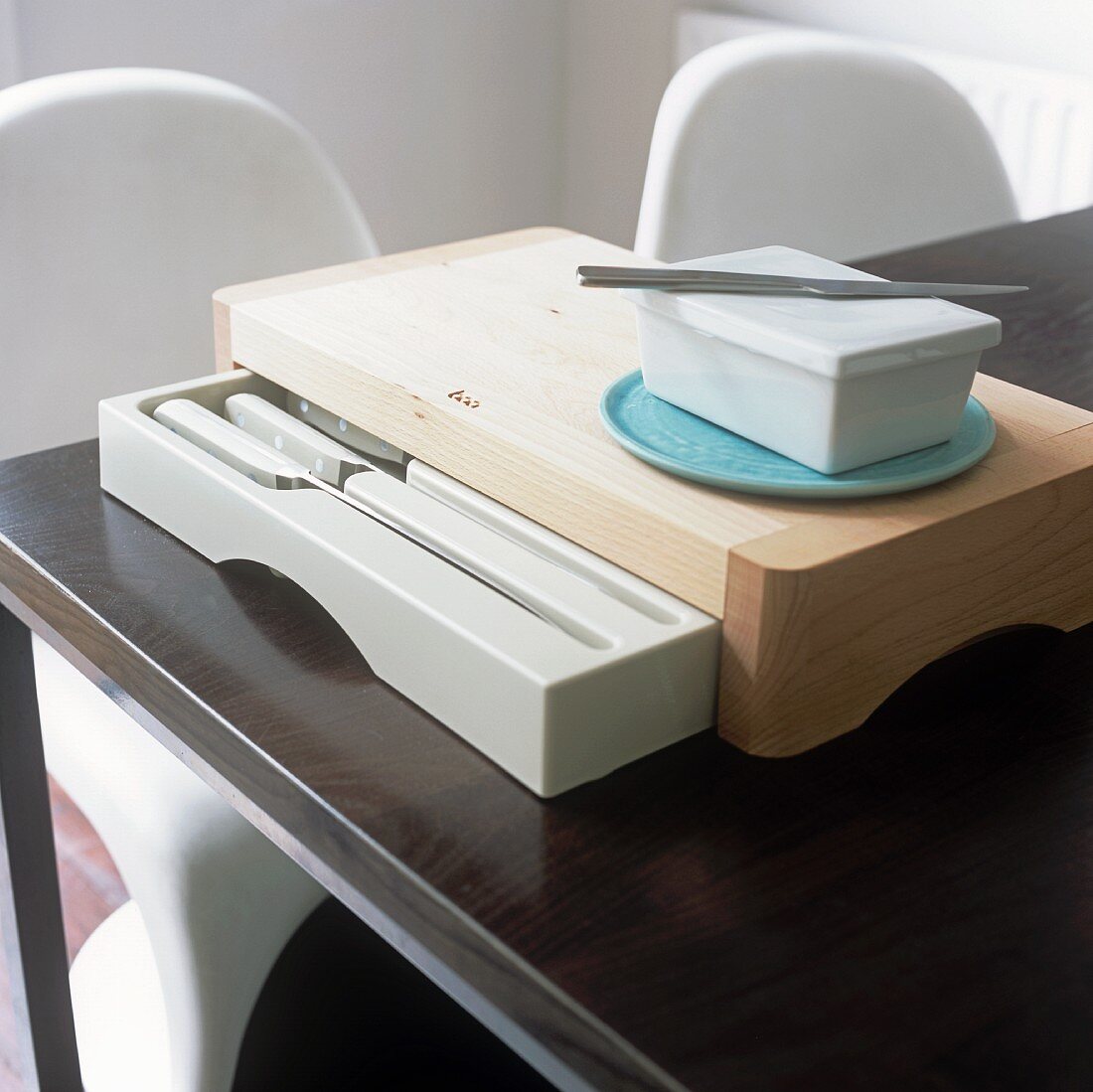 A chopping board with a built-in knife drawer