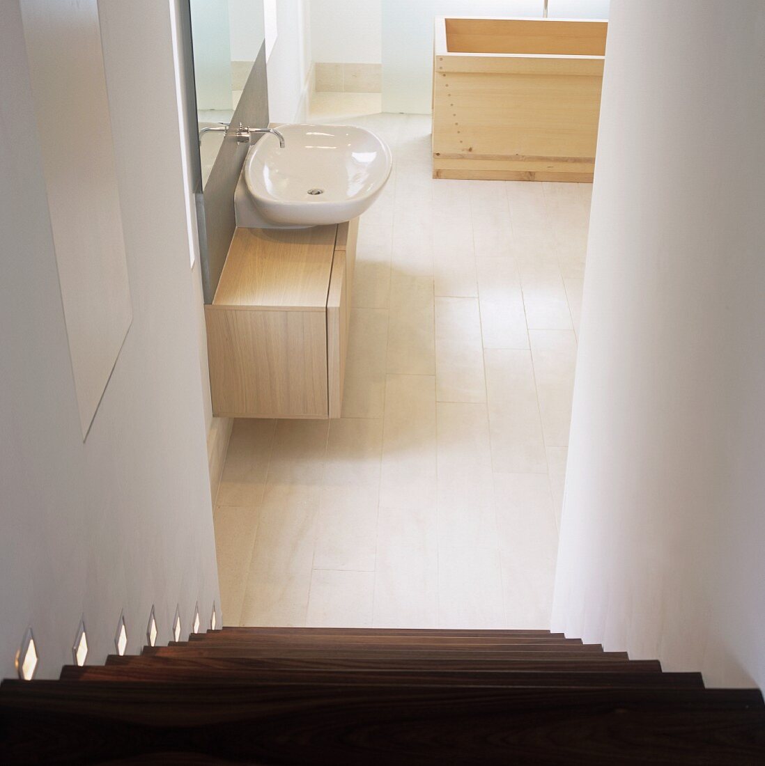 A view into a bathroom from a flight of stairs