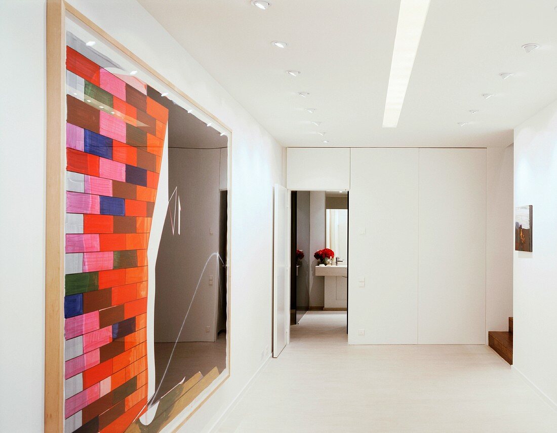 Modernes Bild im minimalistischen weissen Vorraum mit offener Tür