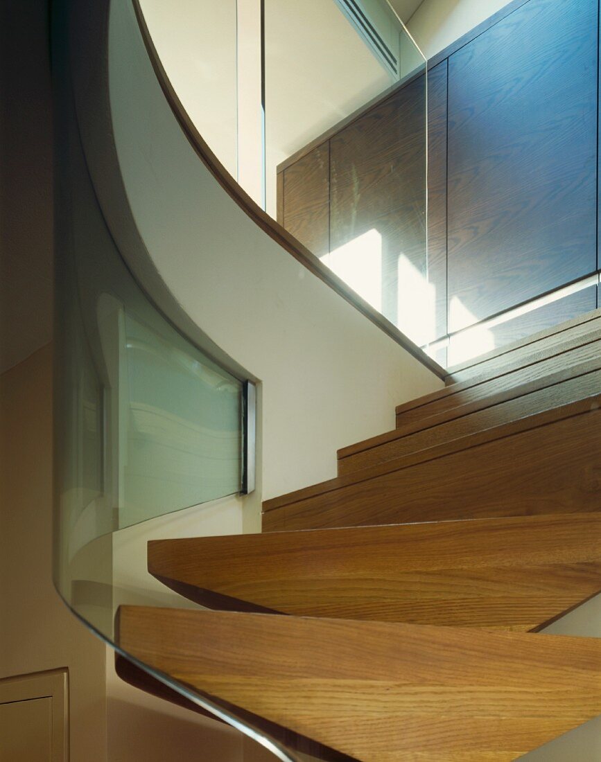 A modern flight of stairs with a glass balustrade