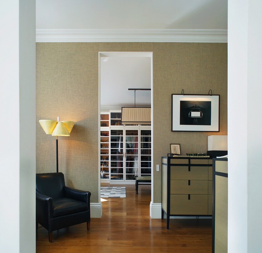 Modern, classic living room with open doorway and view of dressing room