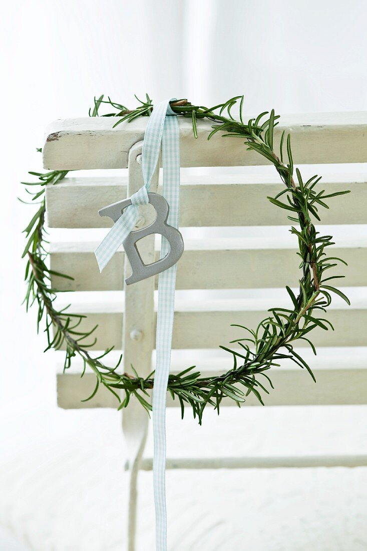 A wreath of rosemary hanging over the back of a chair