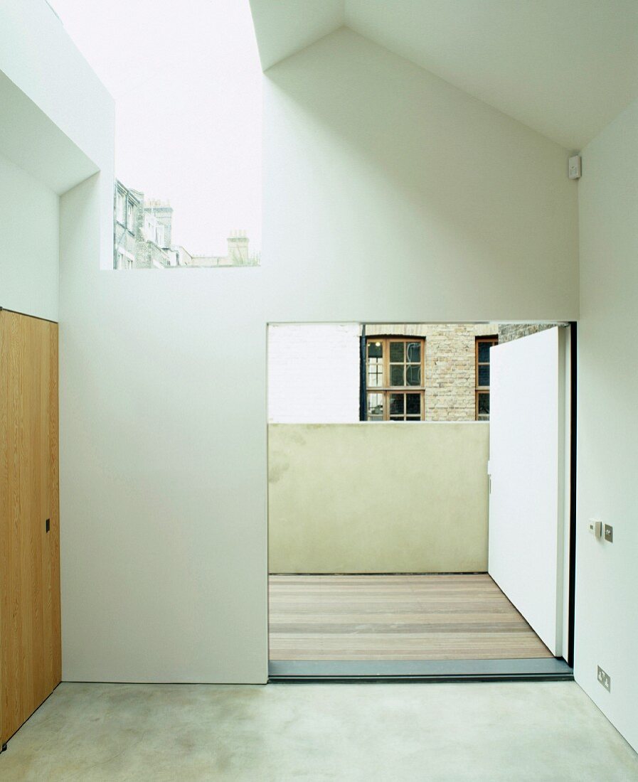 Bare bedroom with skylight and open terrace door