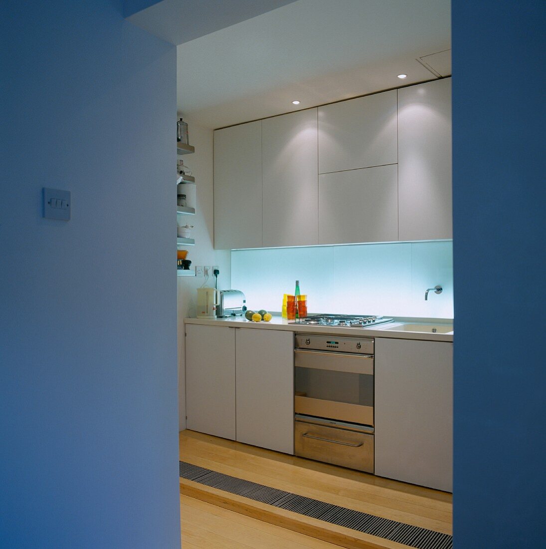 View of functional kitchen through open doorway