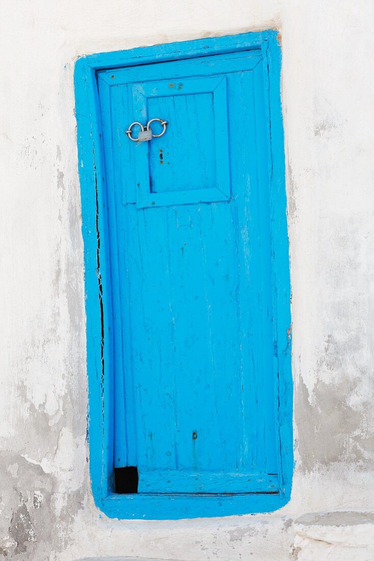 A blue door near a windmill (Greece)