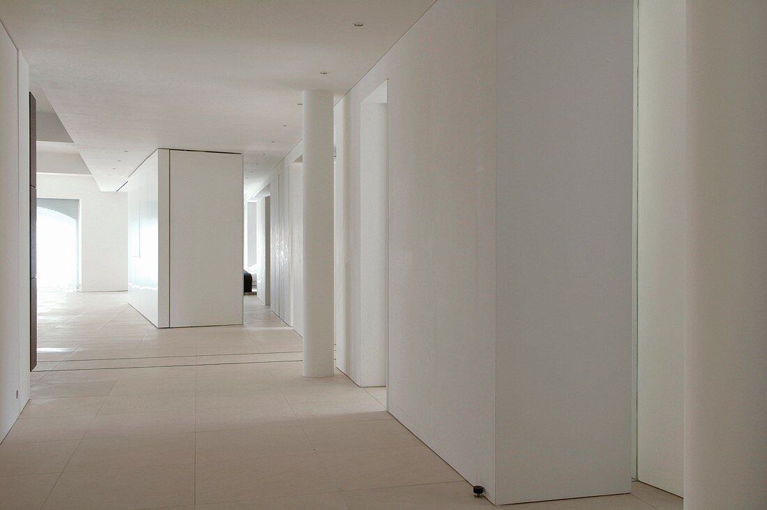 Suite of rooms in white loft interior with free-standing installations
