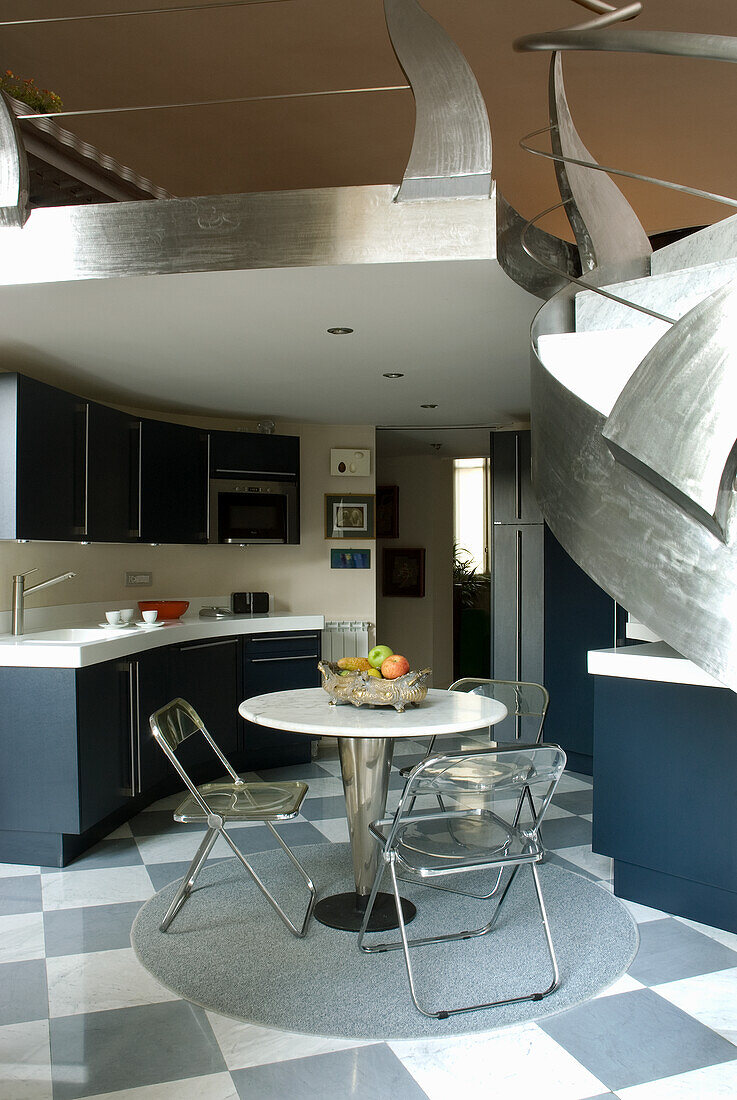 Modern kitchen with chequerboard floor and stainless steel accents