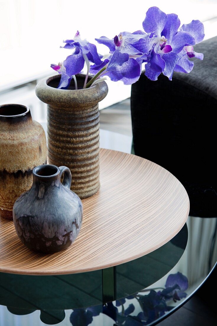 Rustic clay vases and sprig of orchids