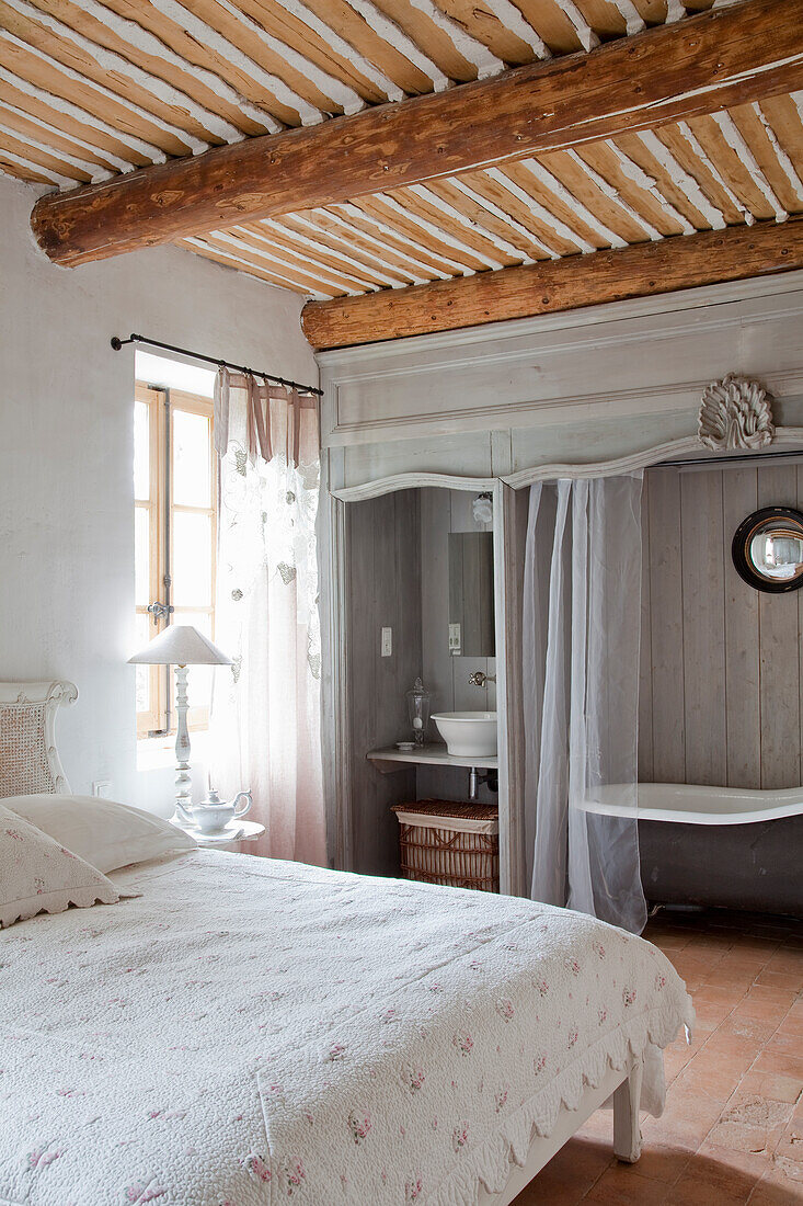 Bedroom with wash area and free-standing bathtub