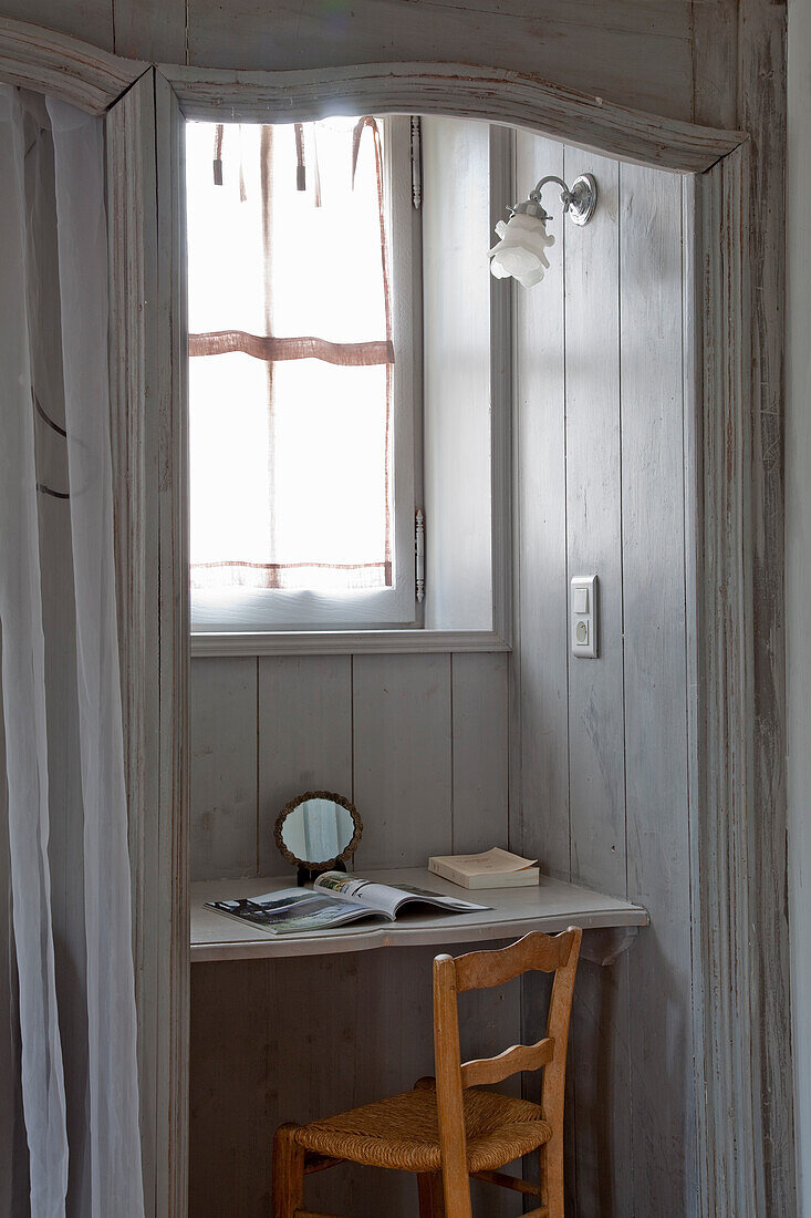 Small workstation in an alcove with window in rustic country house style