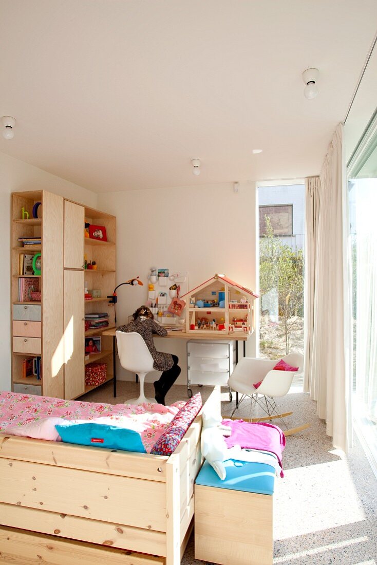Bed and shelf combination made from wood in bright, child's bedroom