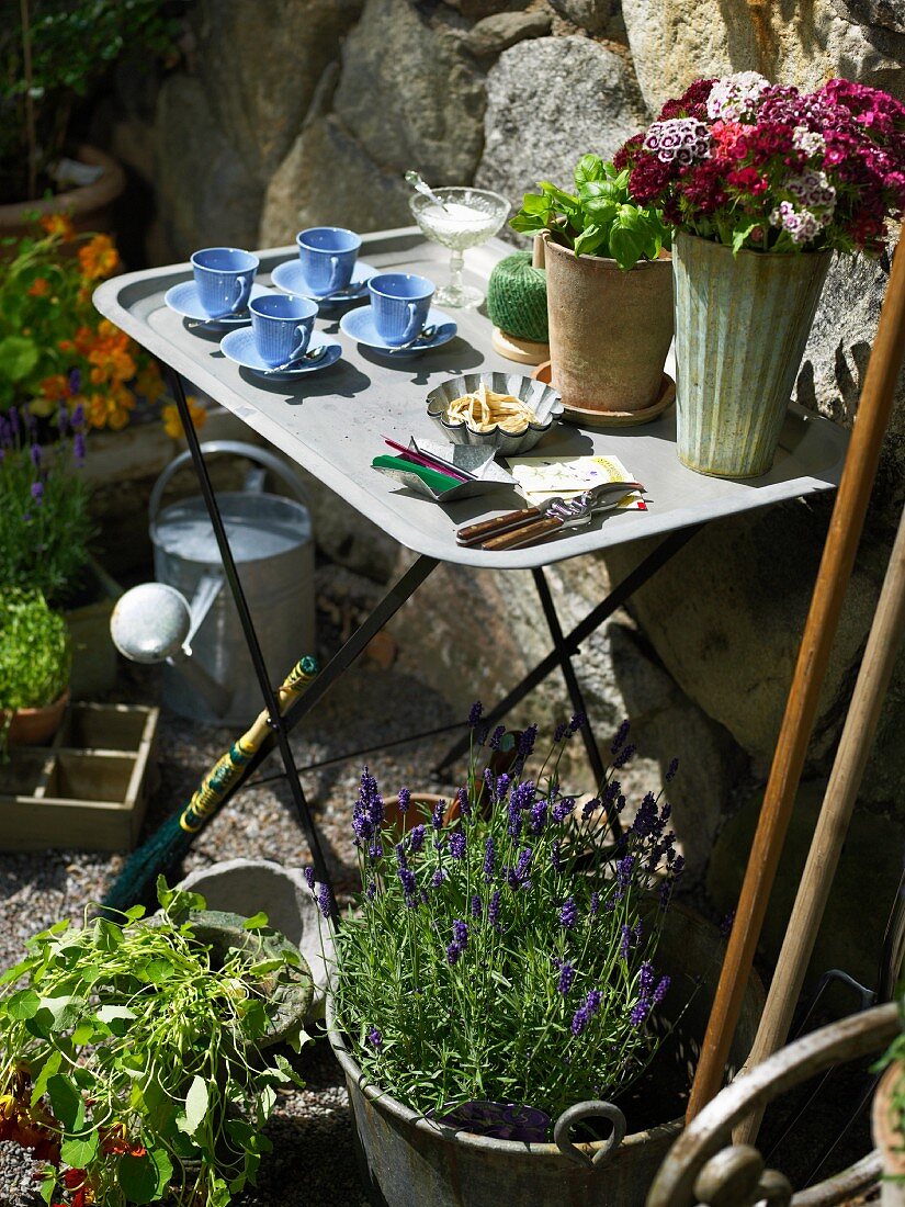 Set side table in a flowering garden