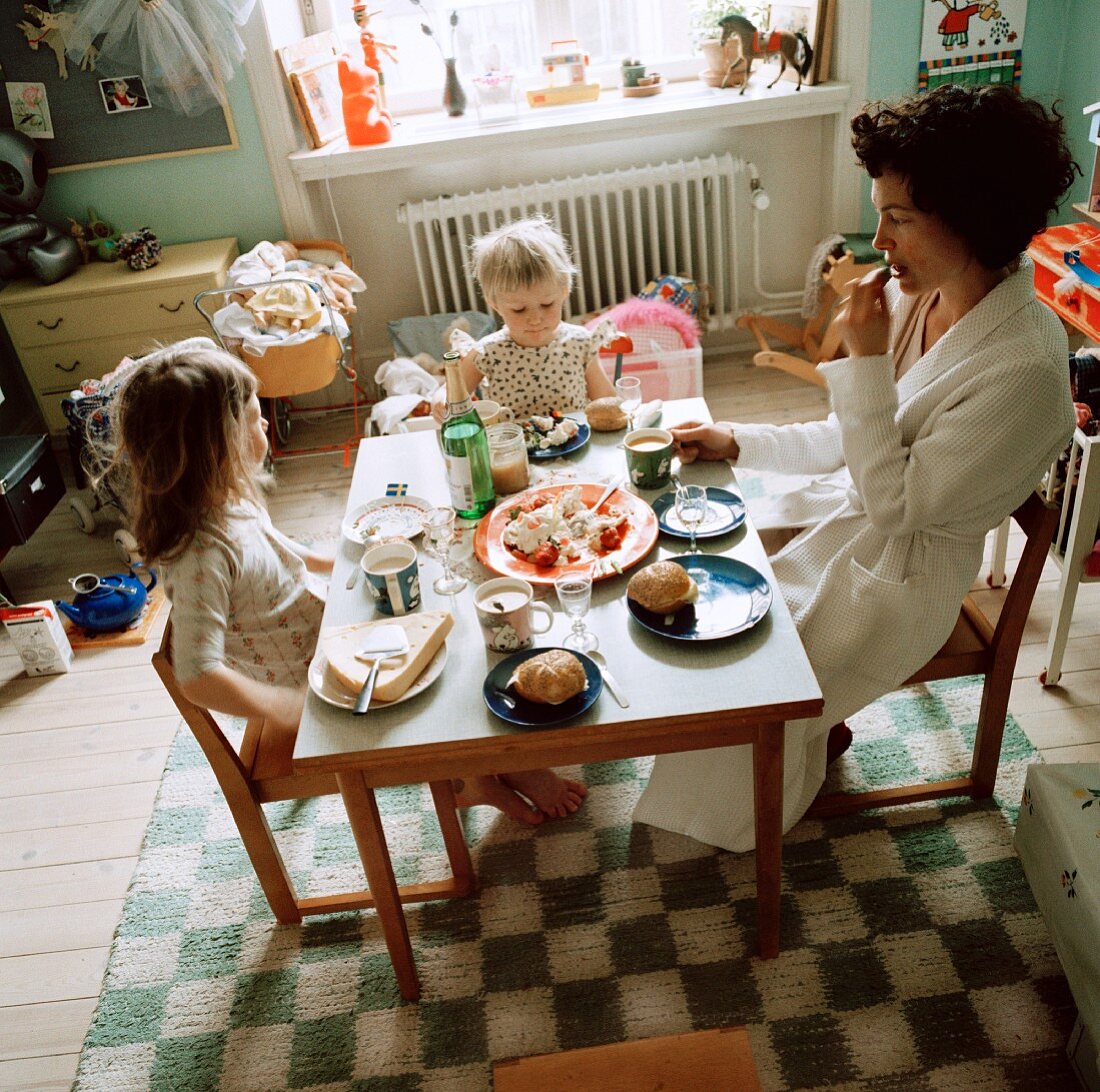 A mother and daughter eating in a nursery