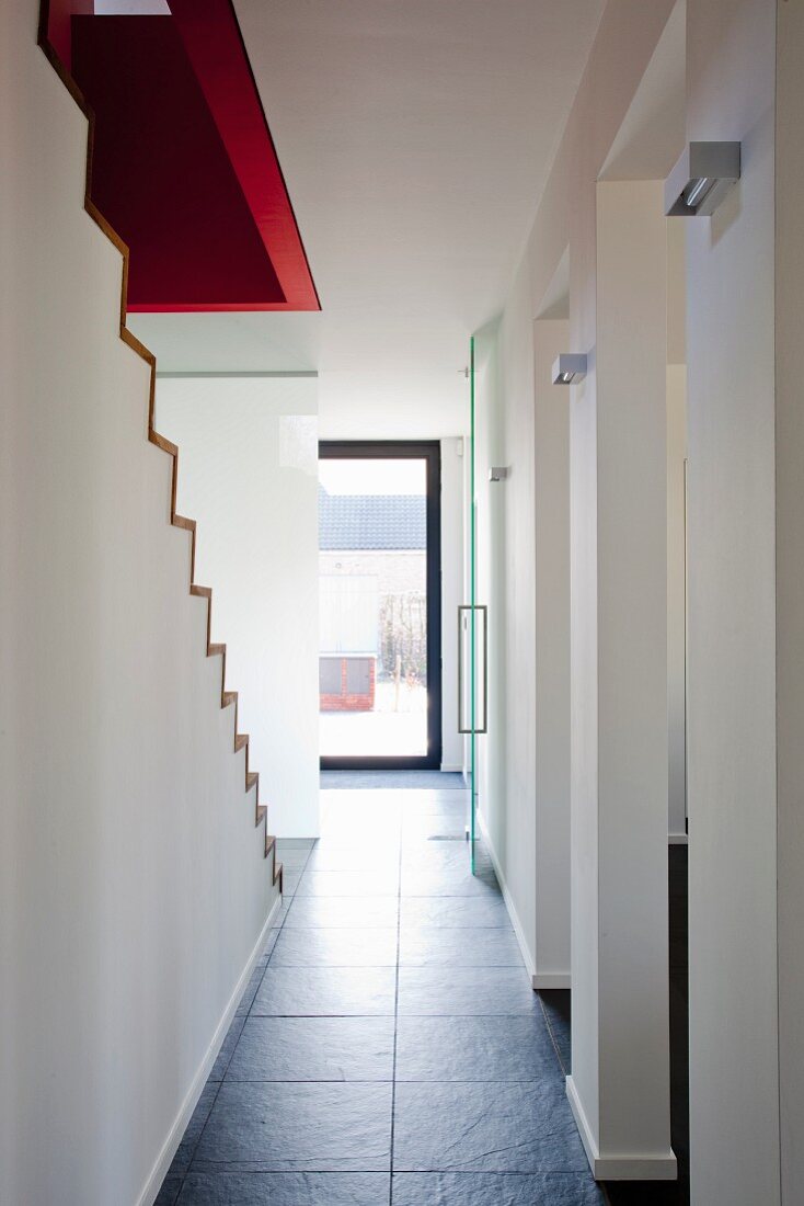 View along minimalist hallway with stone floor