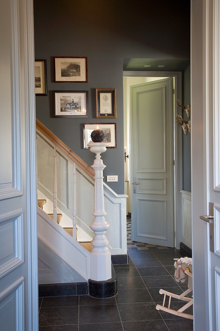 Renovated, English-style country house - white wood and blue-grey walls in hall with turned newel post and balusters on staircase