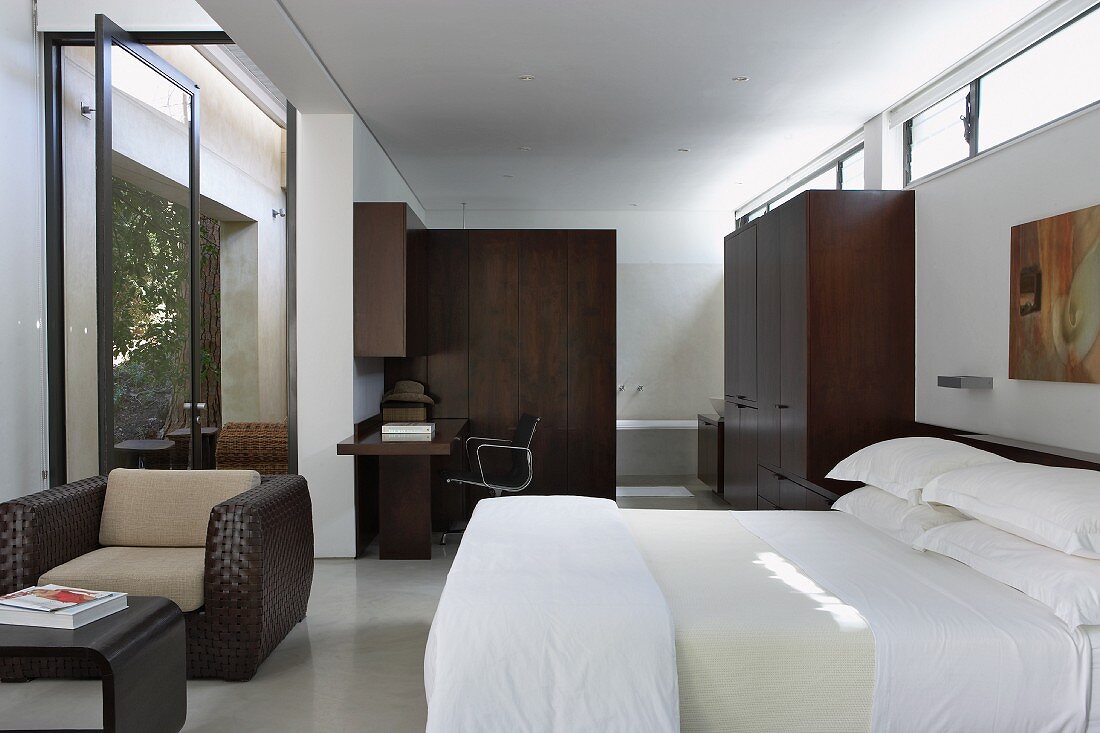 Modern bedroom with dark wood wardrobes