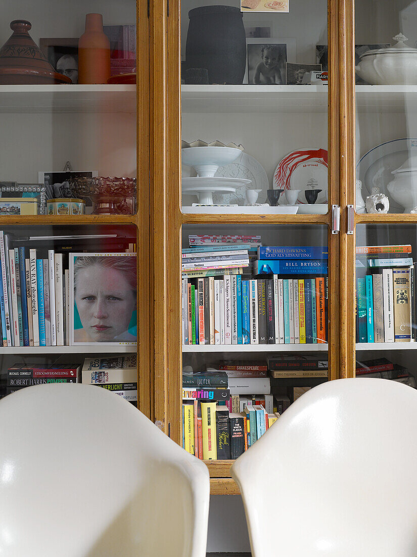 Cupboard with glass front, books and crockery