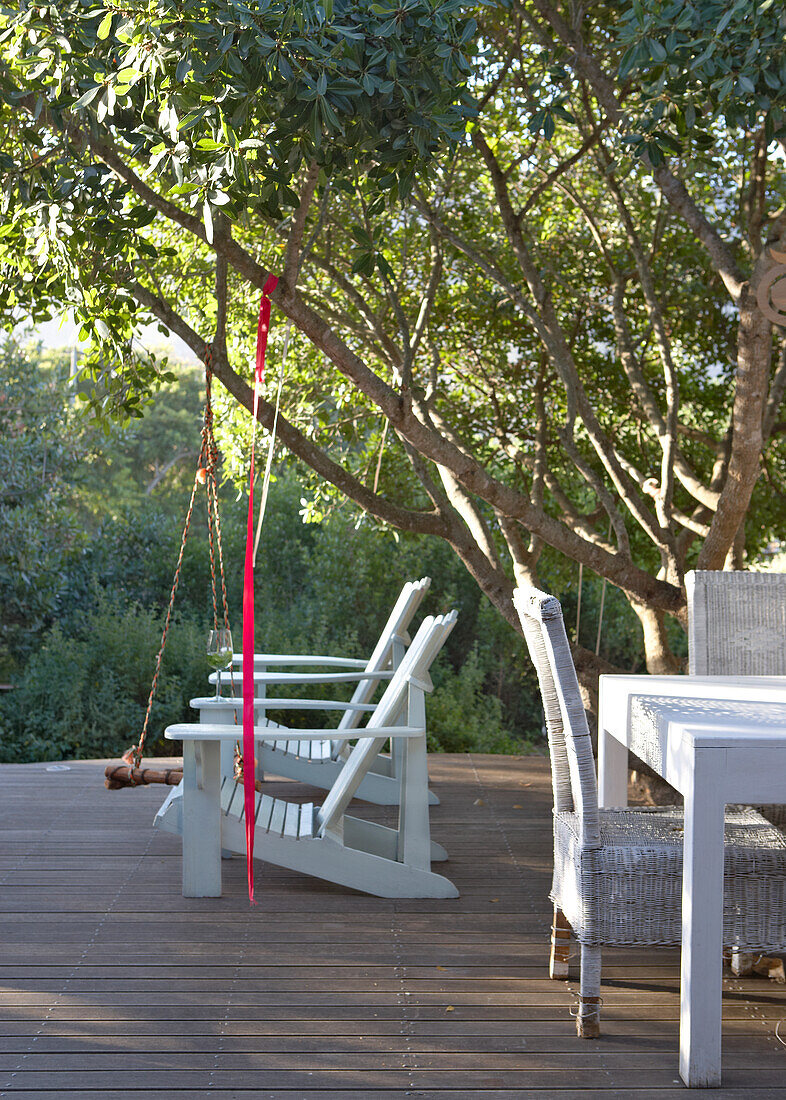 Wooden terrace with furniture in the greenery