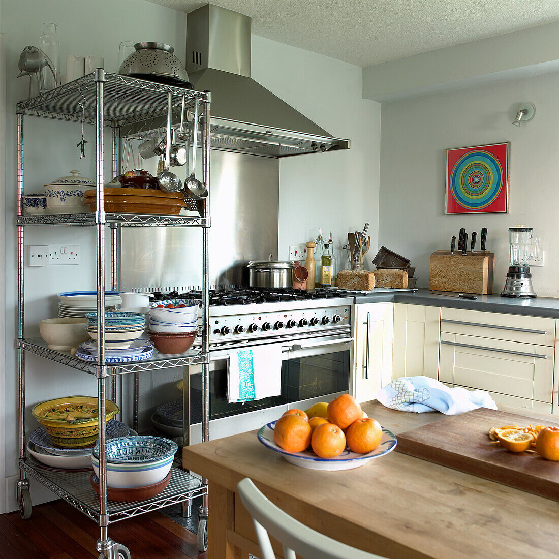 Kitchen with stainless steel shelving and colorful wall art