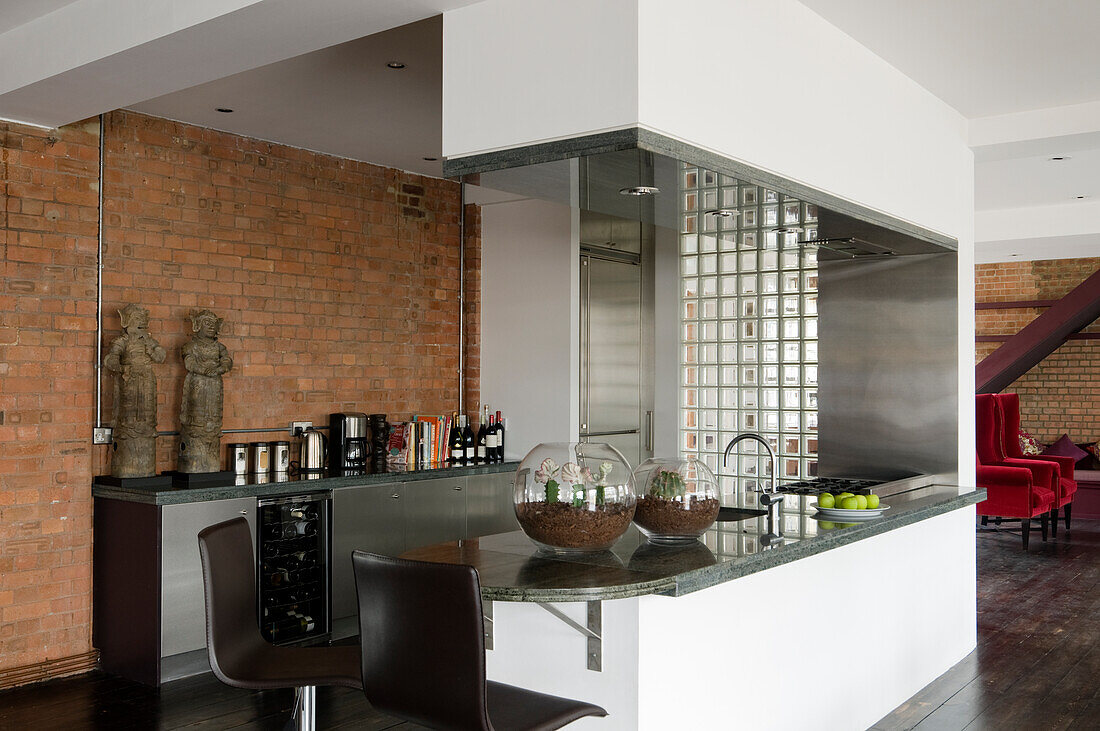 Moderne Küche mit Theke, Glasbausteinwand und Backsteinwand im Loft-Stil