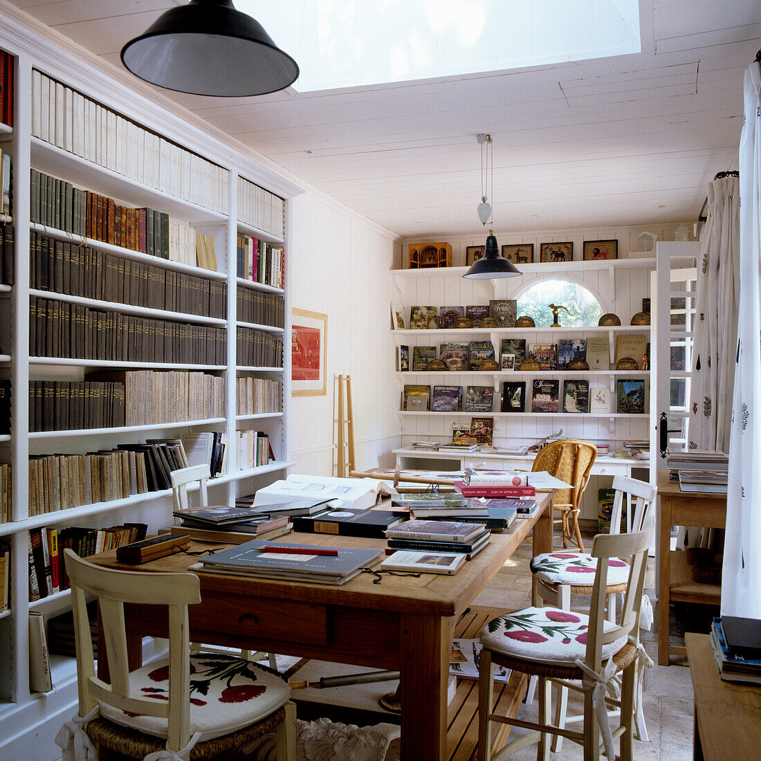 Study with bookshelves, table and chairs