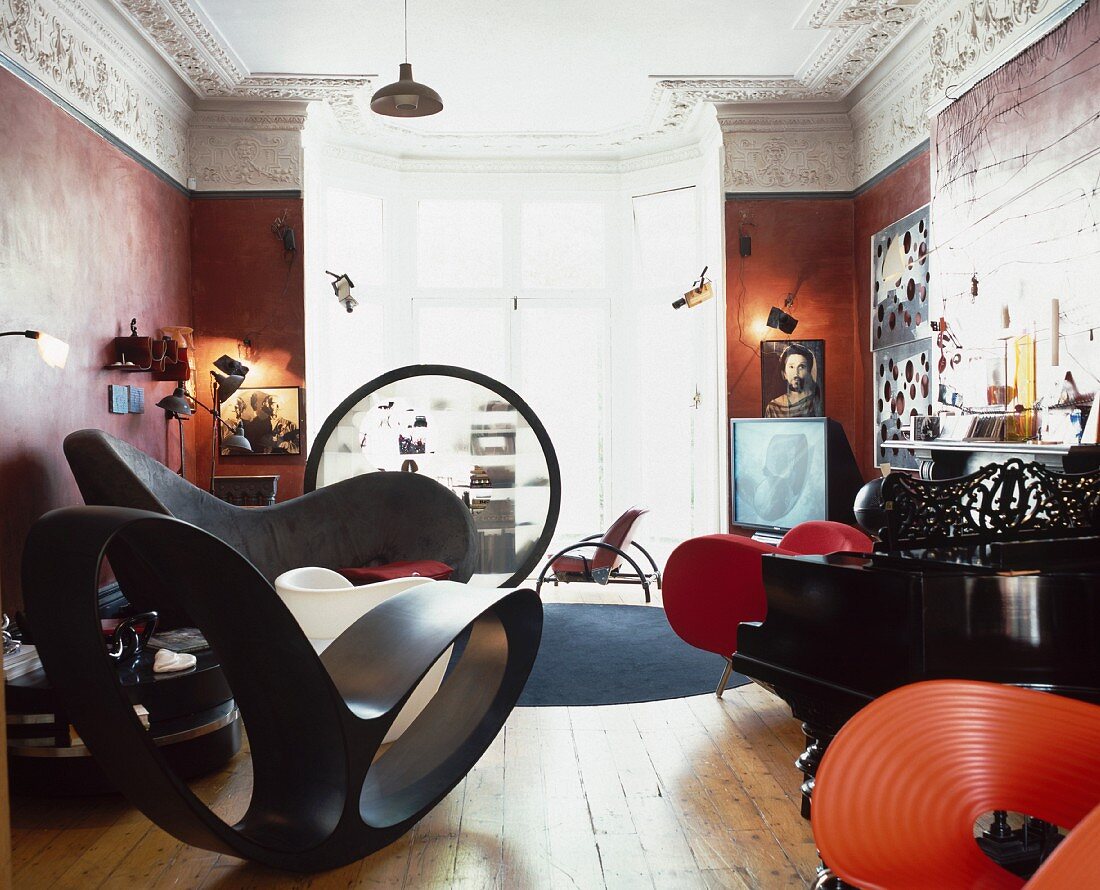 Designer seating and Bauhaus shelves in a luxurious room of a Baroque villa