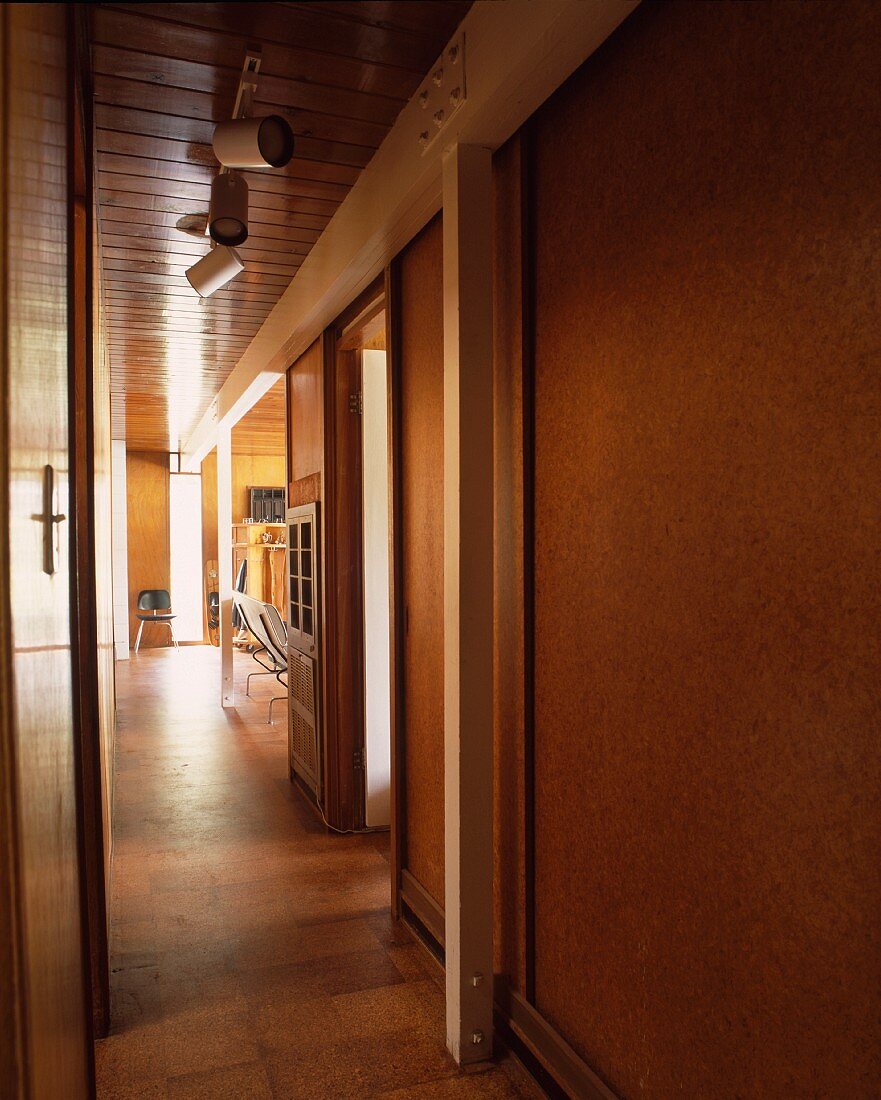 Narrow hall with wood-clad wall